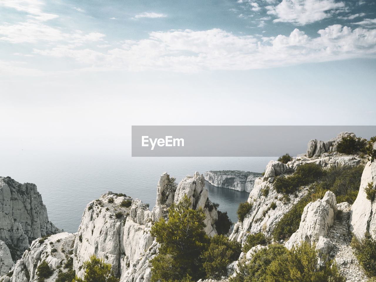 Panoramic view of sea and mountains against sky