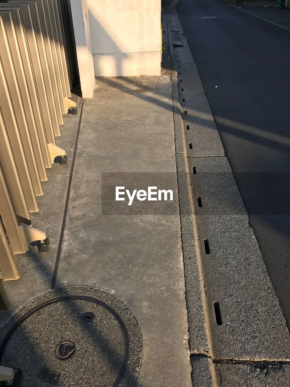 HIGH ANGLE VIEW OF MANHOLE ON STREET