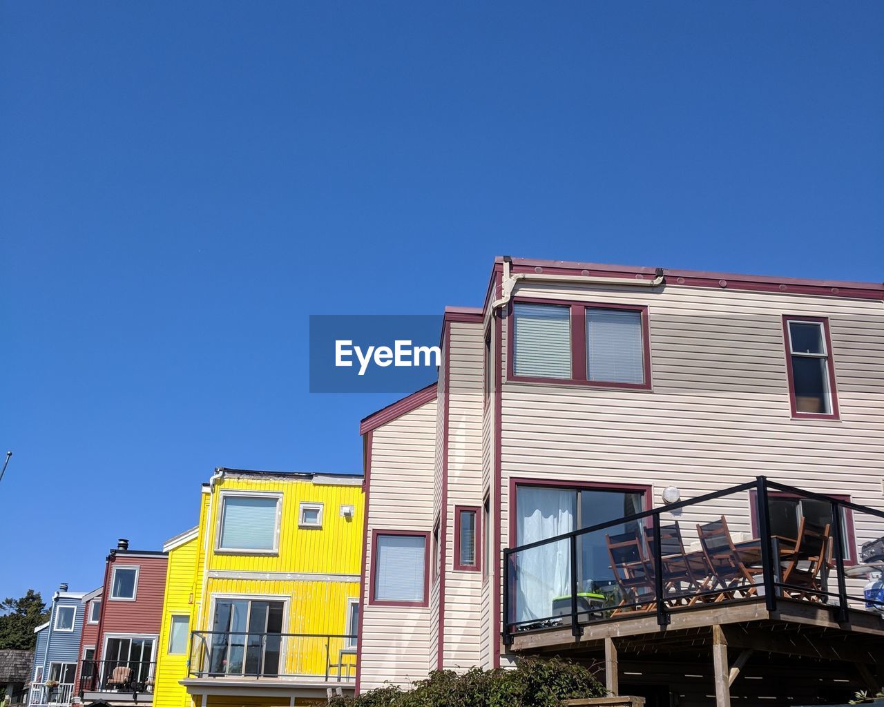 LOW ANGLE VIEW OF BUILDINGS AGAINST BLUE SKY