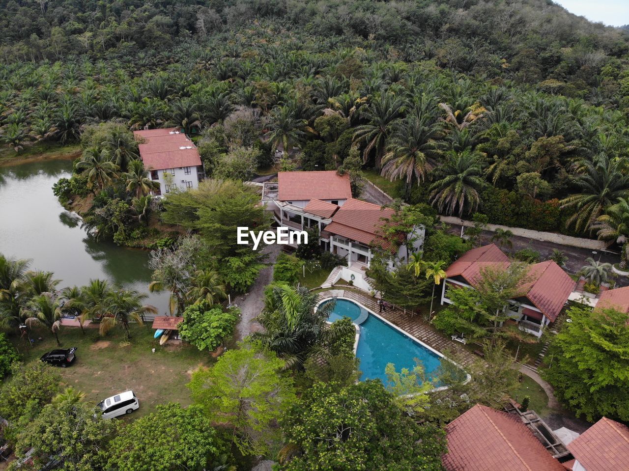 High angle view of swimming pool by buildings in forest