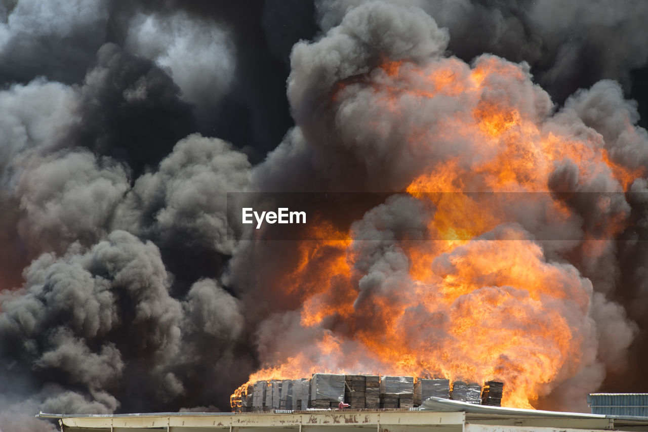 Smoke emitting from burning crates in factory