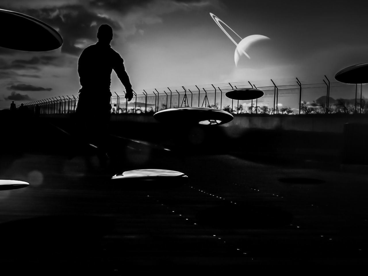 Silhouette of a person with a planet in the background