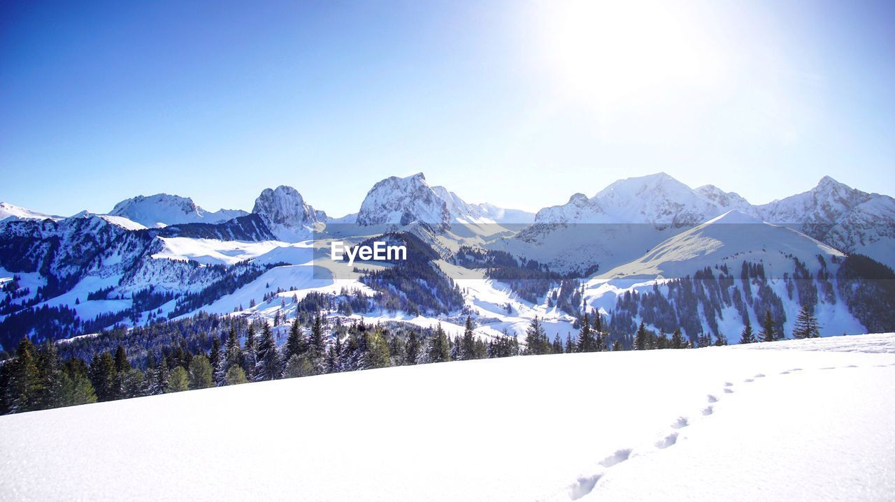 Scenic view of snowcapped mountains against clear sky