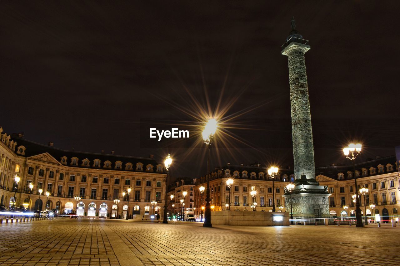 ILLUMINATED CITY BUILDINGS AT NIGHT