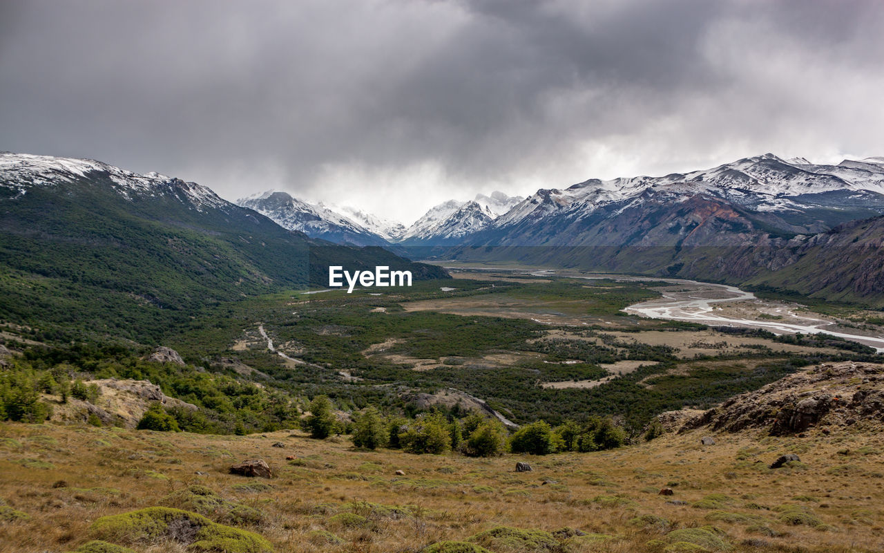 Scenic view of mountains against cloudy sky