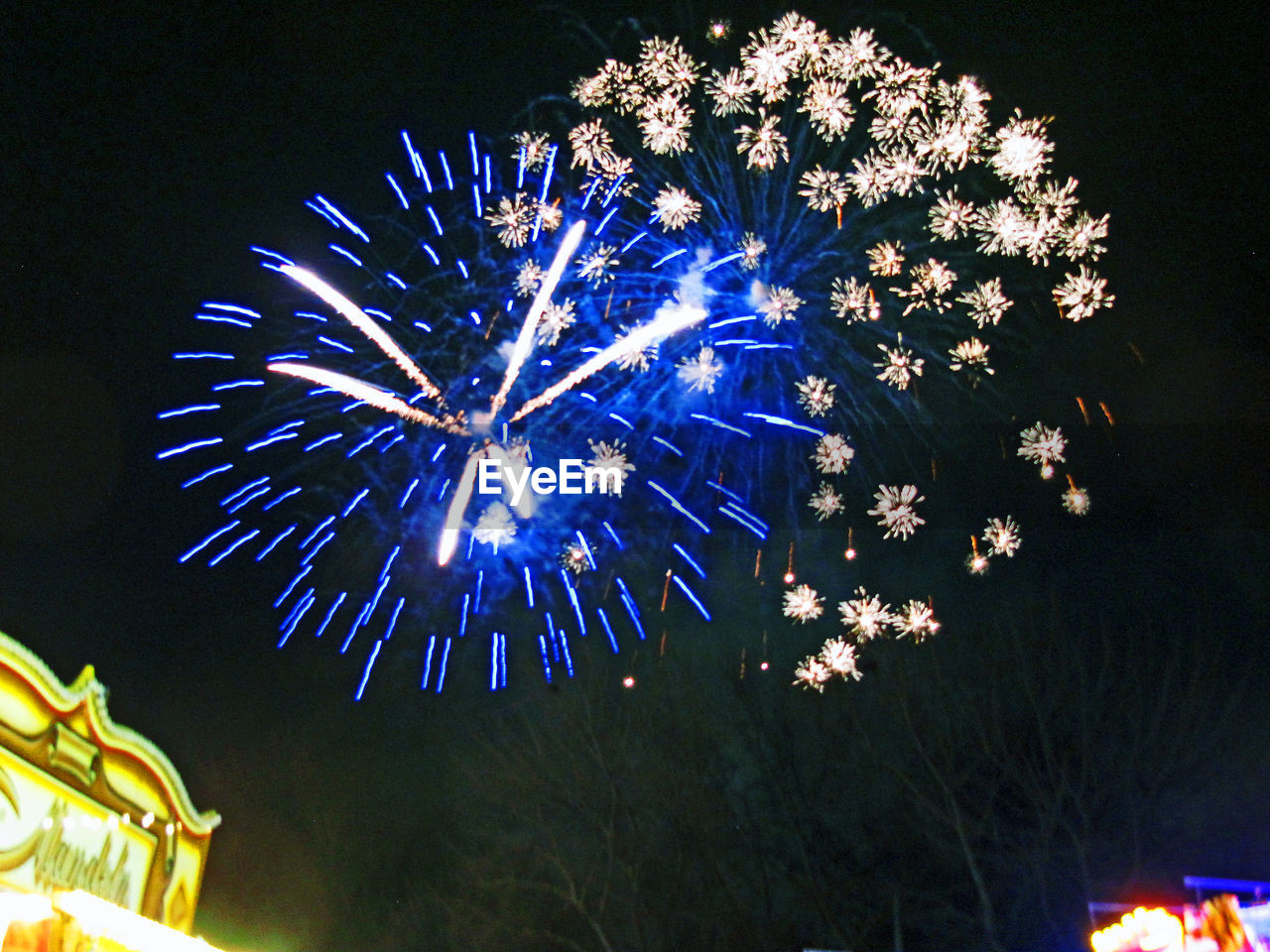 Low angle view of firework display against sky at night