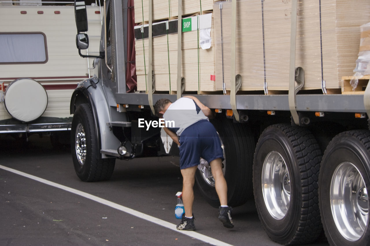 FULL LENGTH OF A MAN IN A HIGH ANGLE VIEW OF A TRUCK