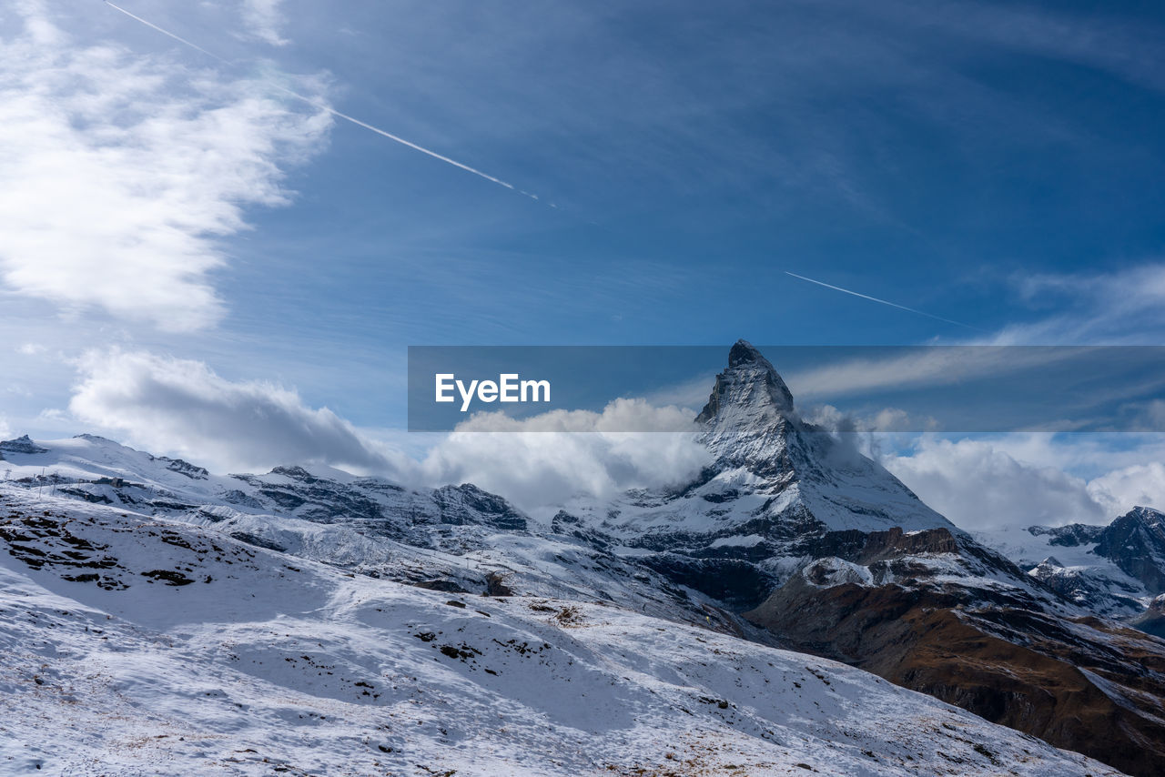 Scenic view of snowcapped mountains against sky