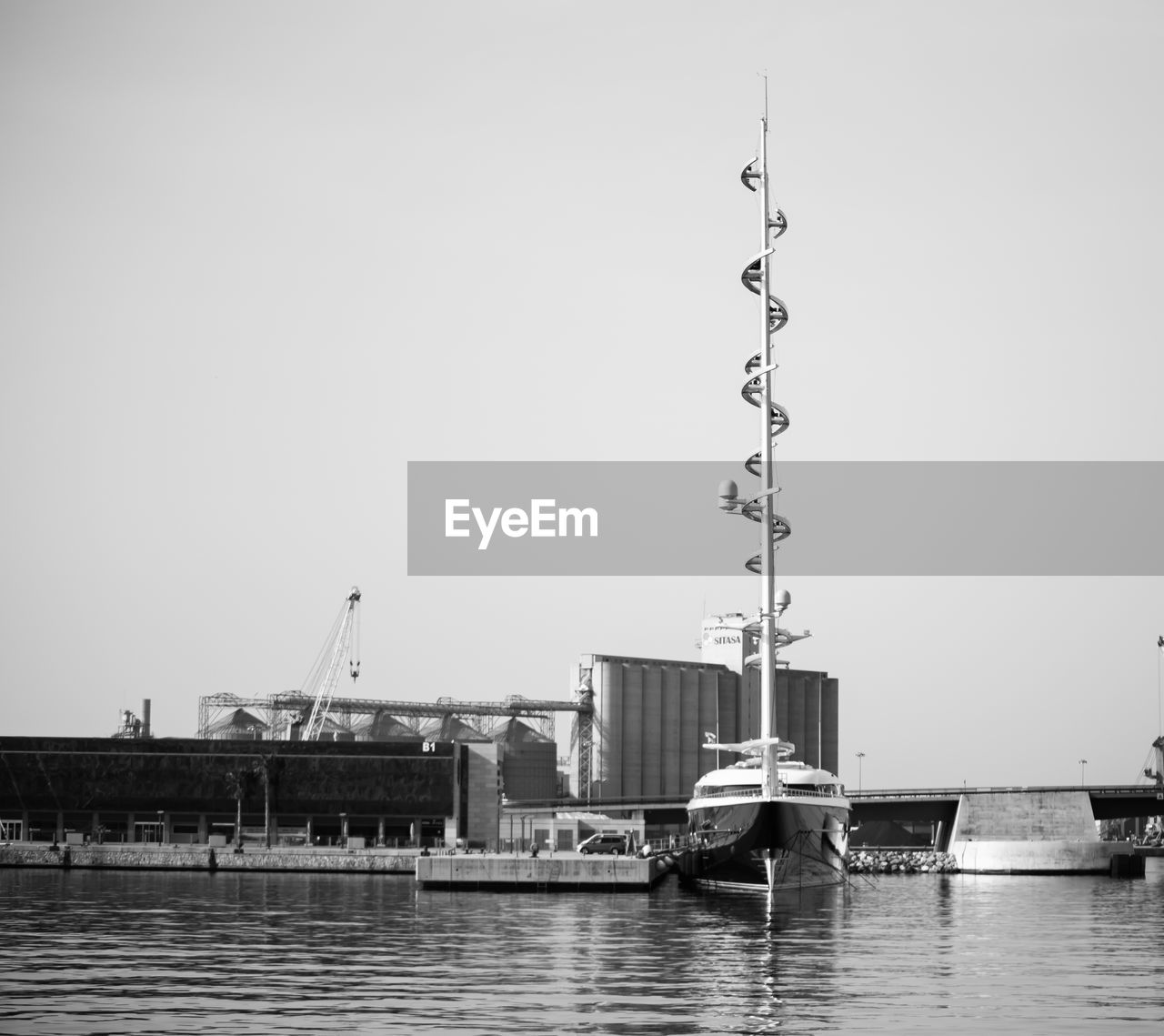 Sailboats moored in sea against clear sky