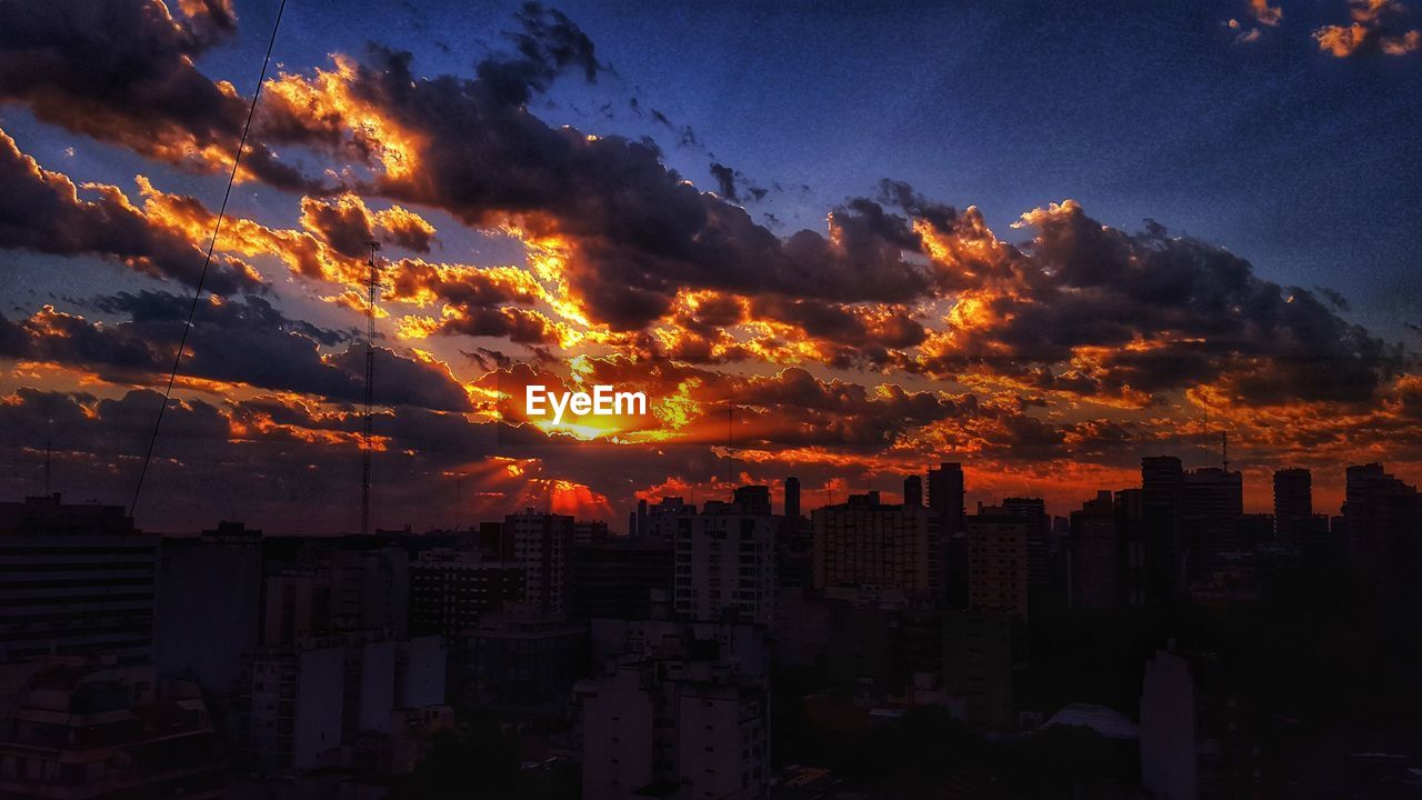 AERIAL VIEW OF BUILDINGS IN CITY DURING SUNSET