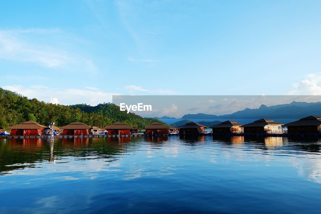 SCENIC VIEW OF LAKE BY MOUNTAIN AGAINST SKY