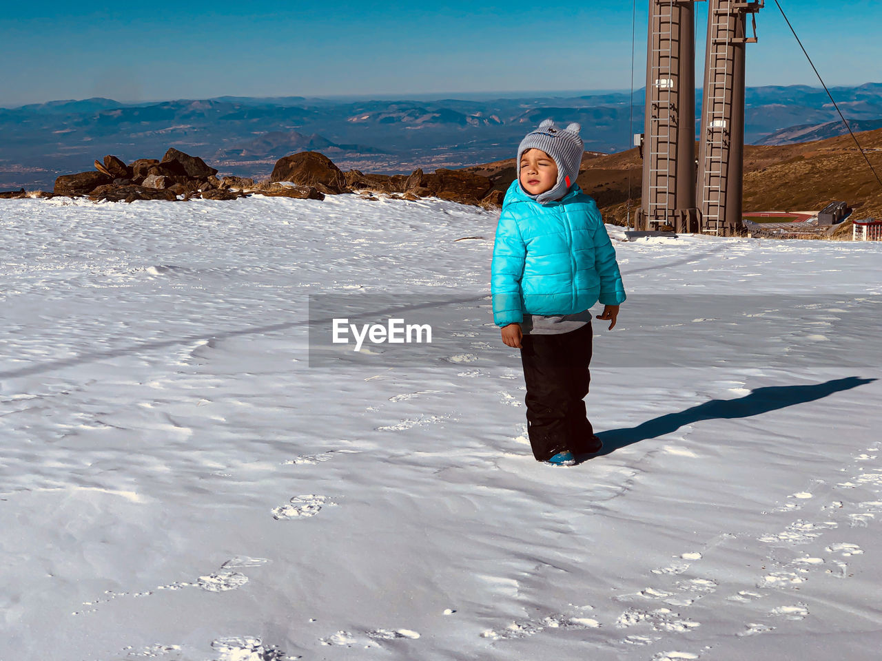 Little boy in the snow of the mountains of sierra nevada