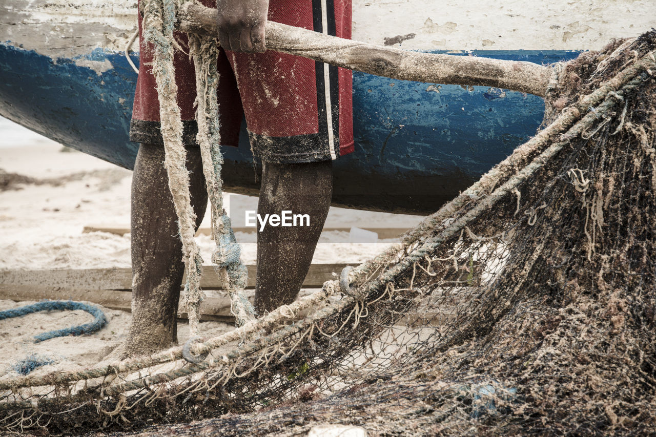 Fishermen taking the big net to the colony.