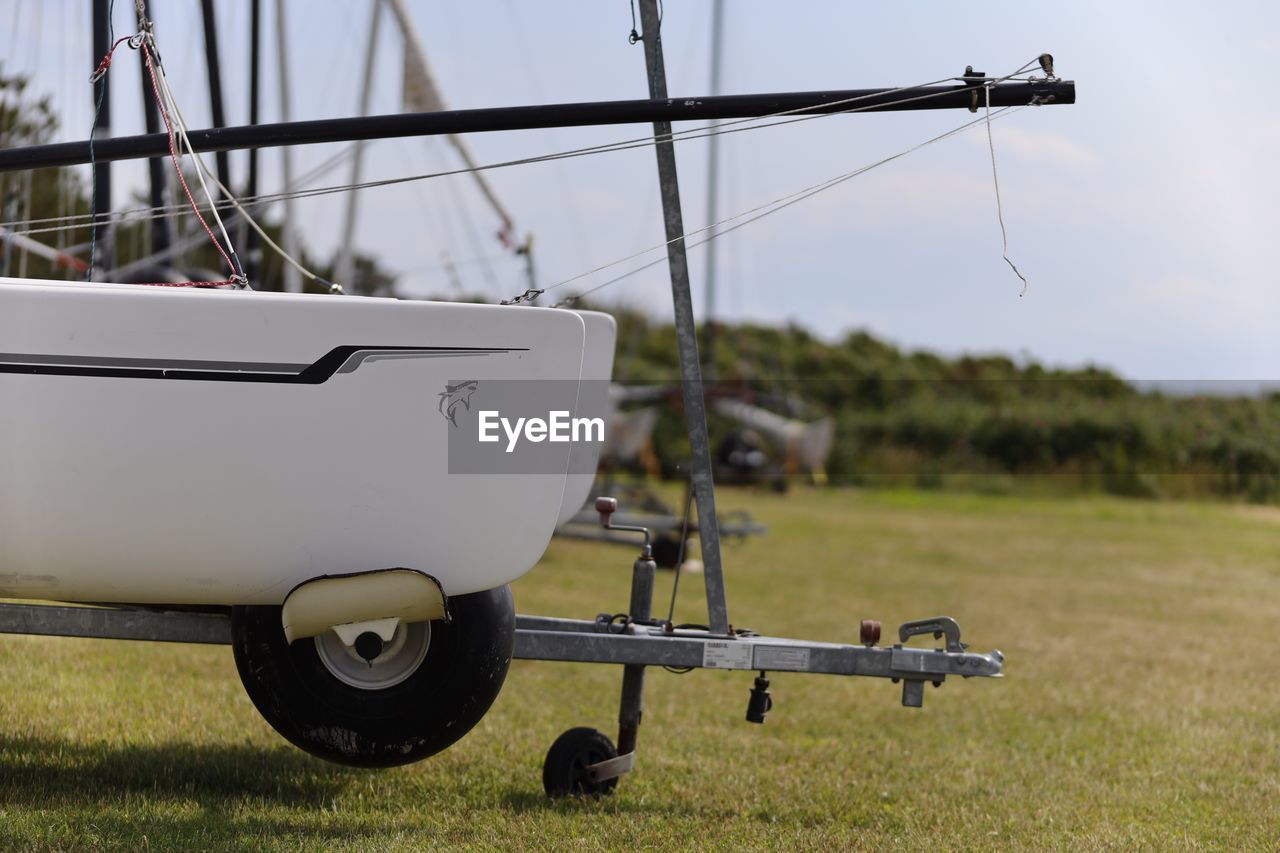 Boat on field against sky