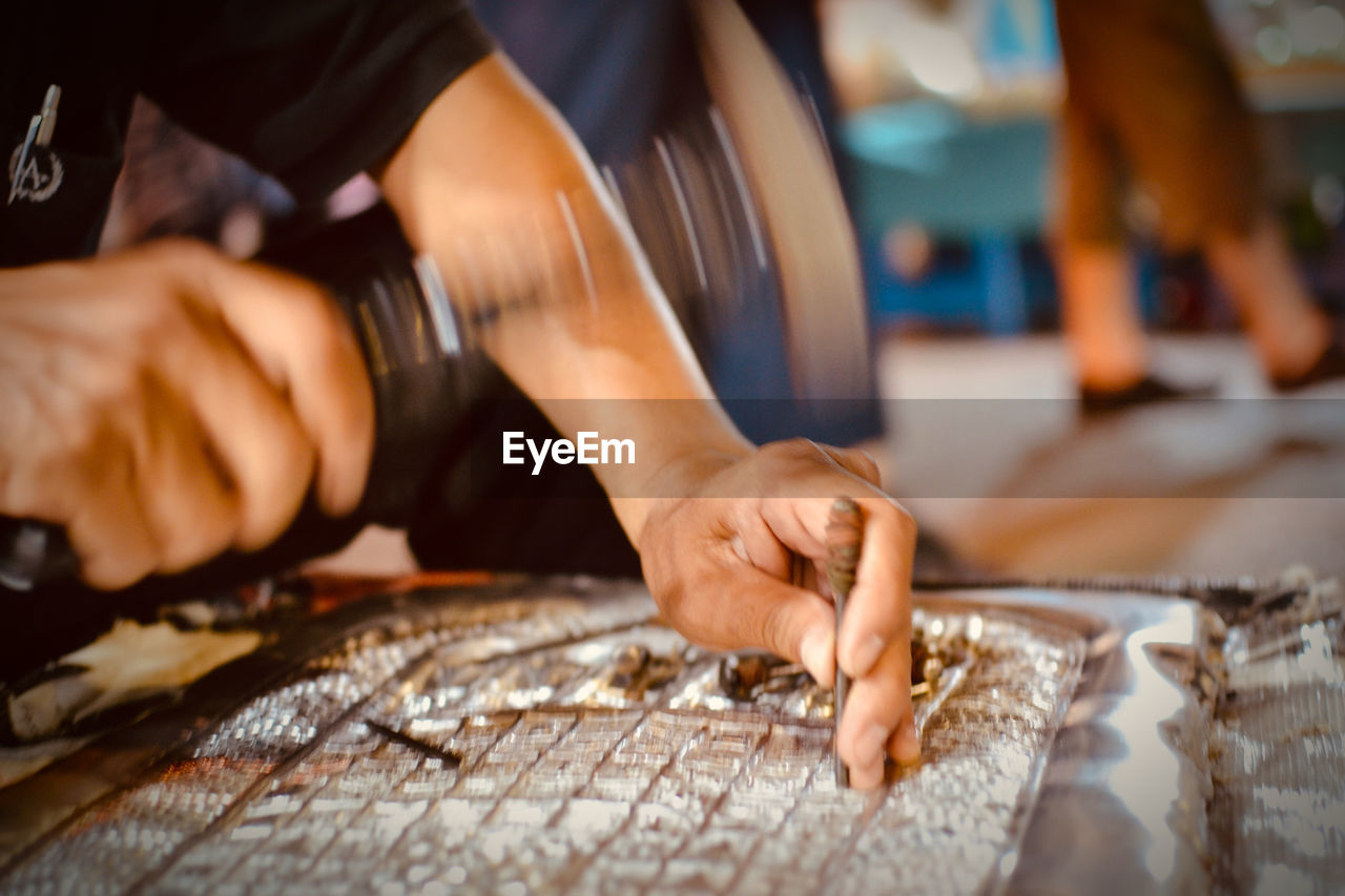 Midsection of man working on table