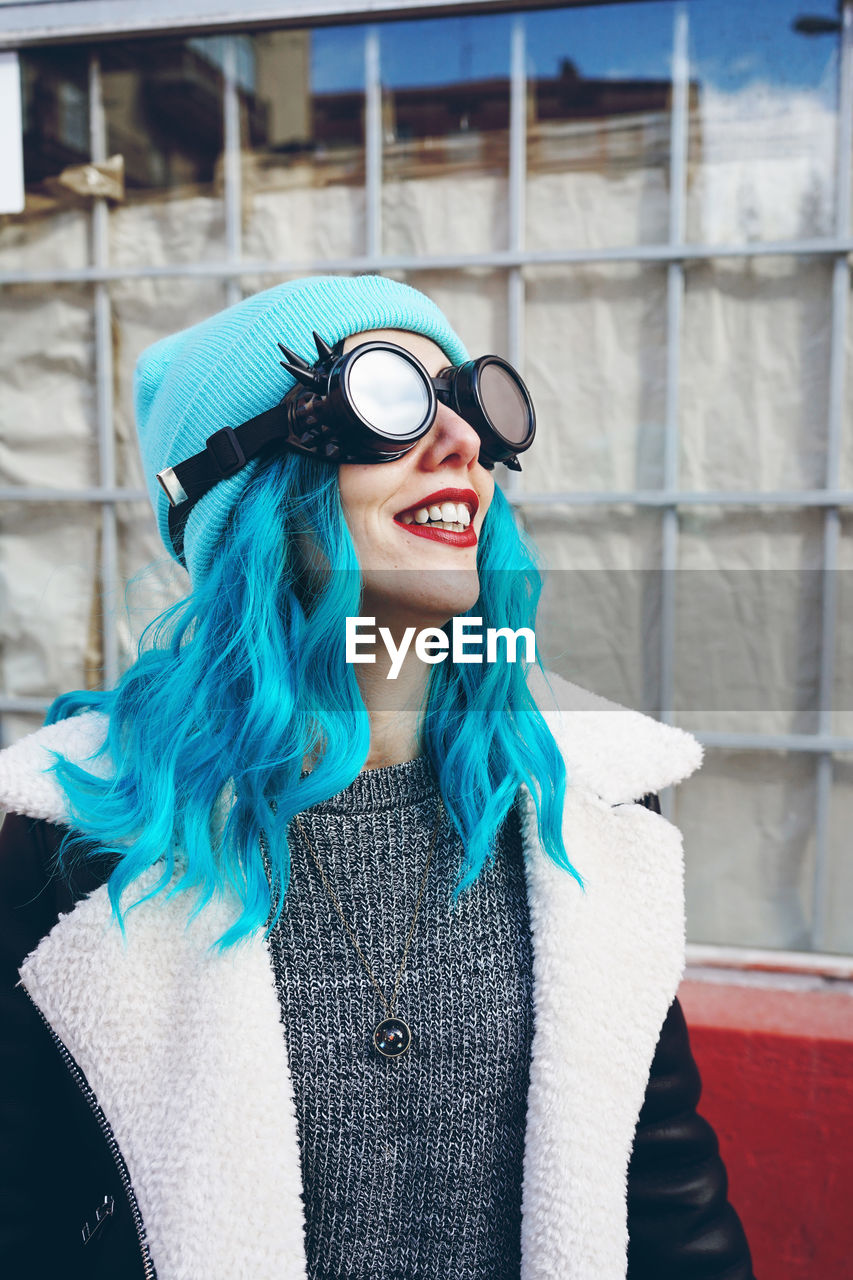 Close-up of fashionable woman with dyed blue hair in city