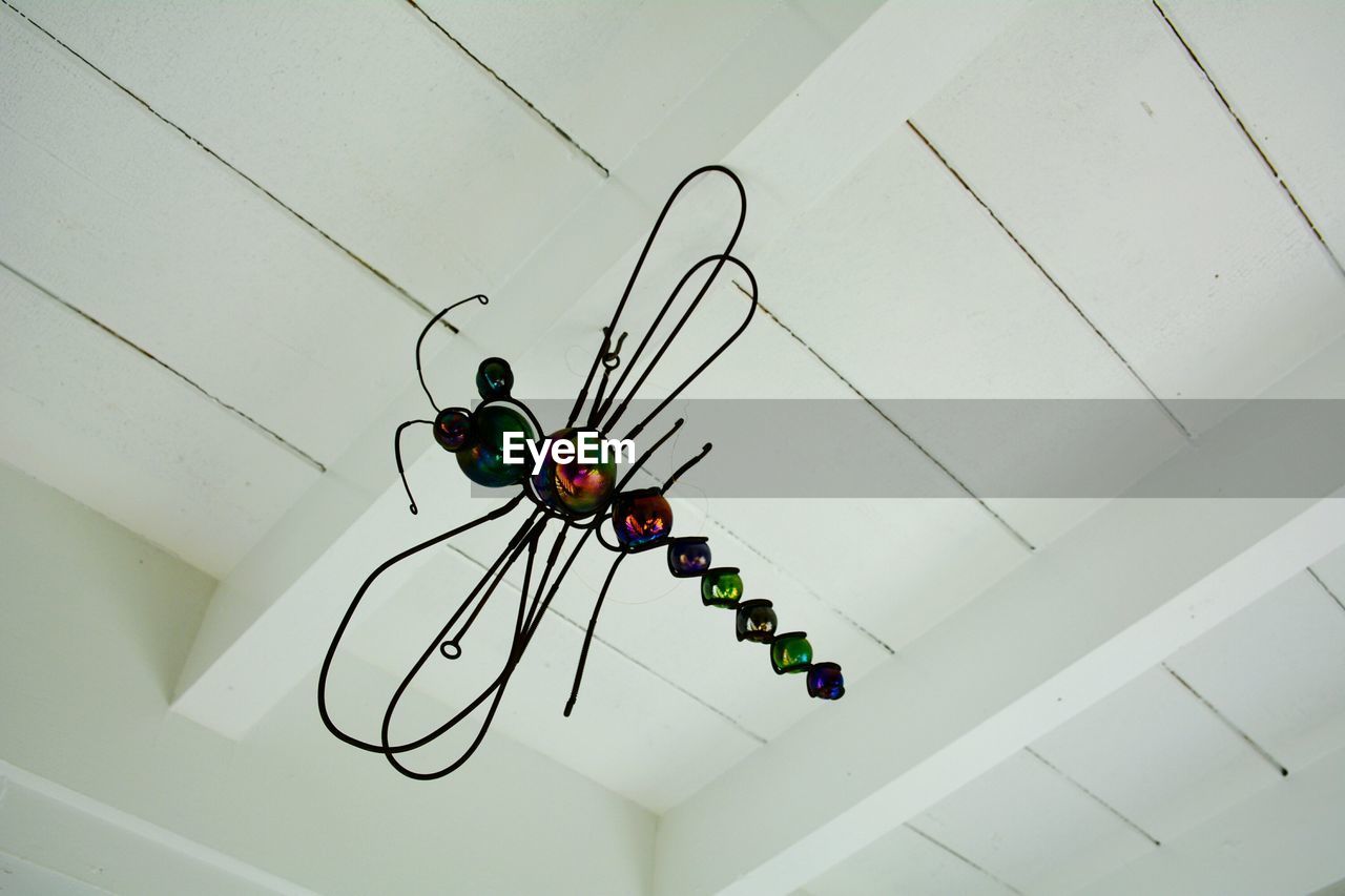 LOW ANGLE VIEW OF LIGHTING EQUIPMENT HANGING ON WALL