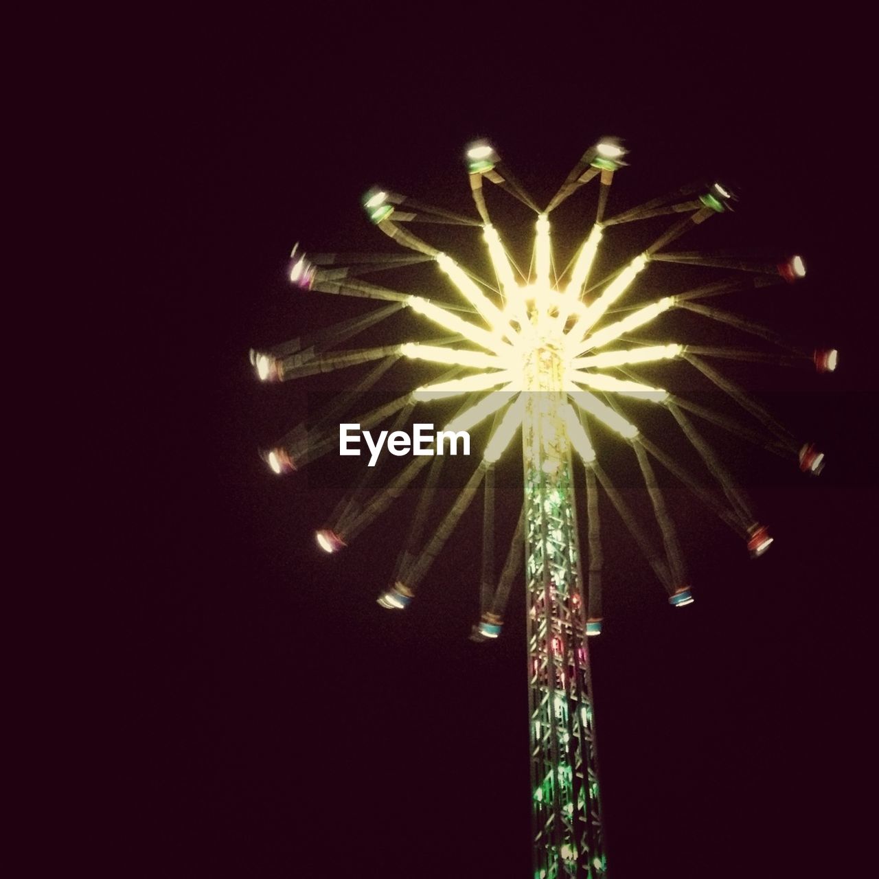 LOW ANGLE VIEW OF FIREWORK DISPLAY AT NIGHT
