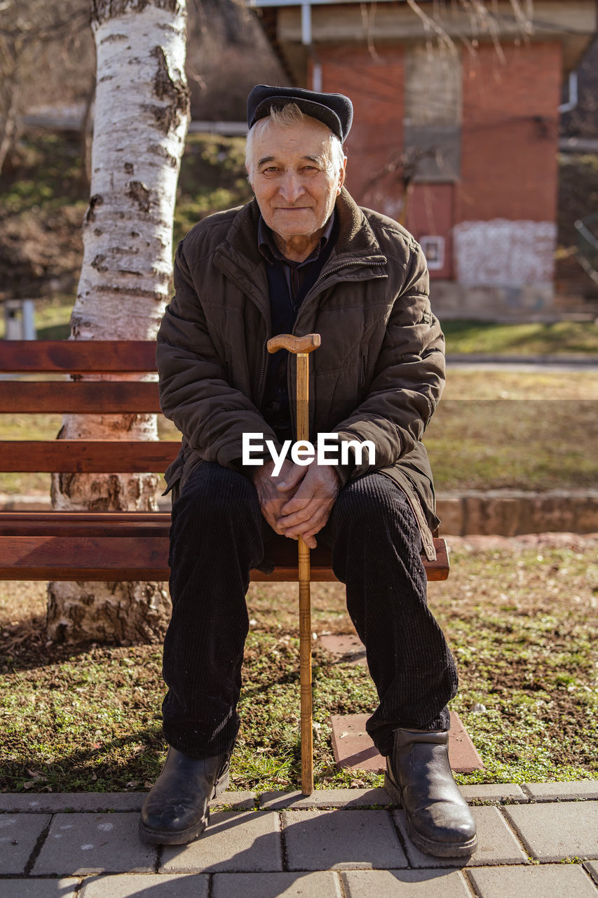 Portrait of man sitting on bench