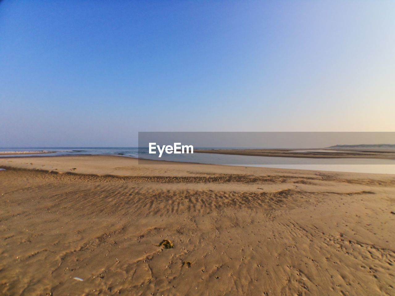 Scenic view of beach against clear sky