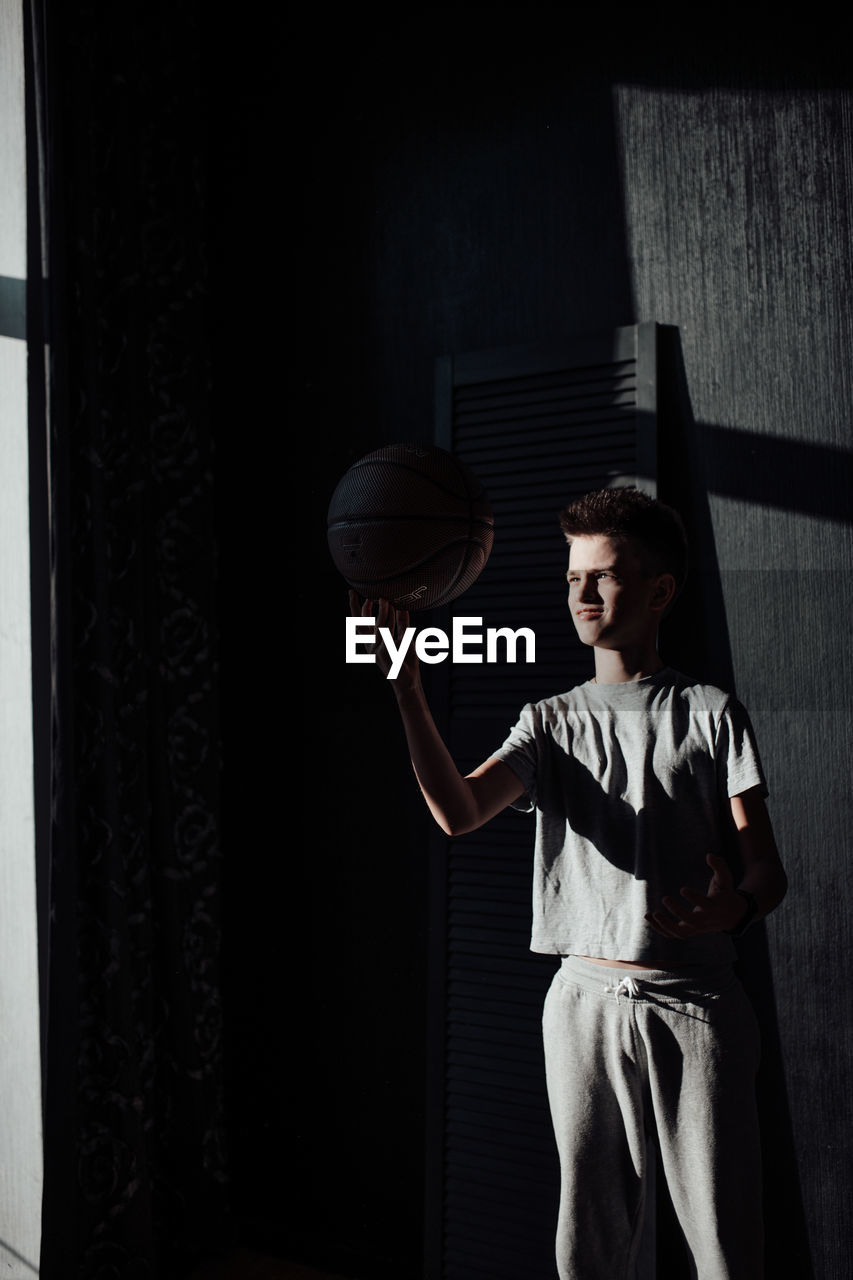 Teenage boy playing with ball