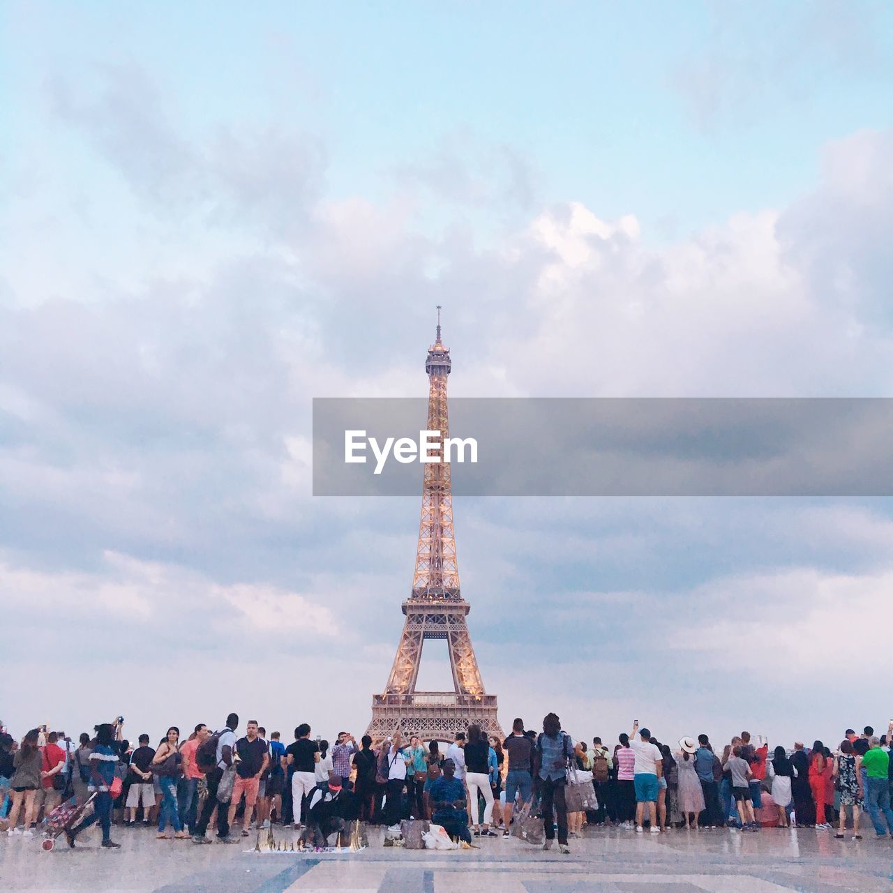 GROUP OF PEOPLE VISITING TOWER AGAINST SKY