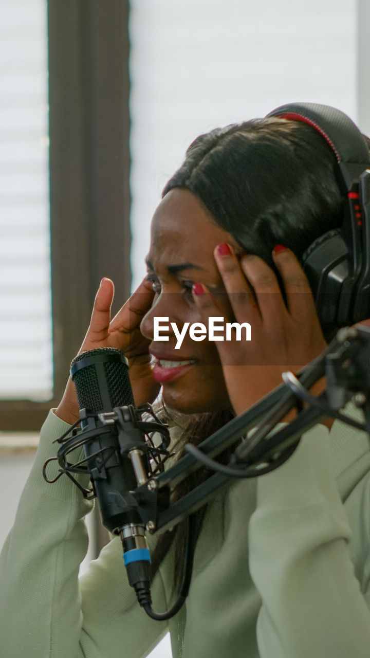 Close-up of young woman in recording studio