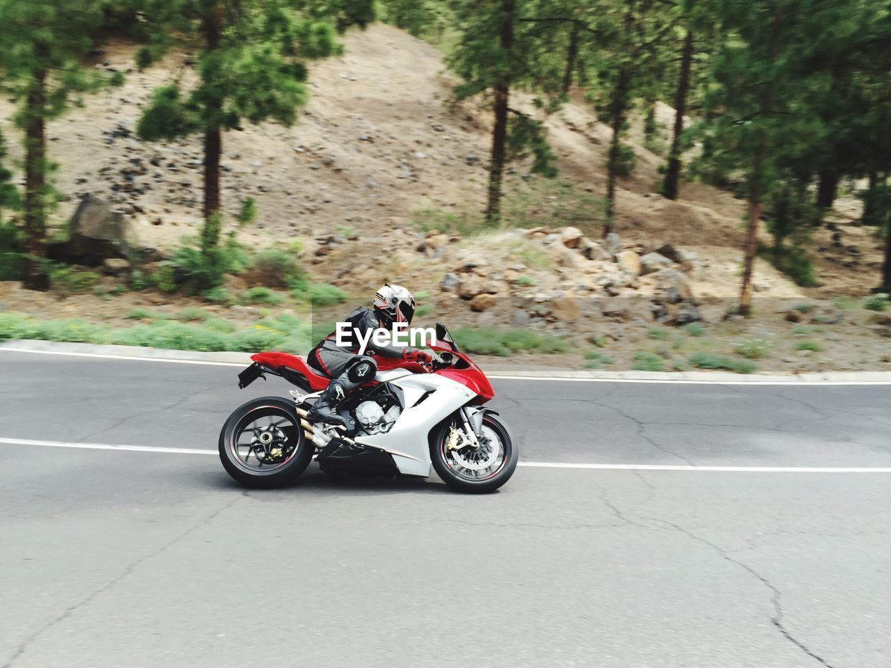 Man riding motorcycle on road