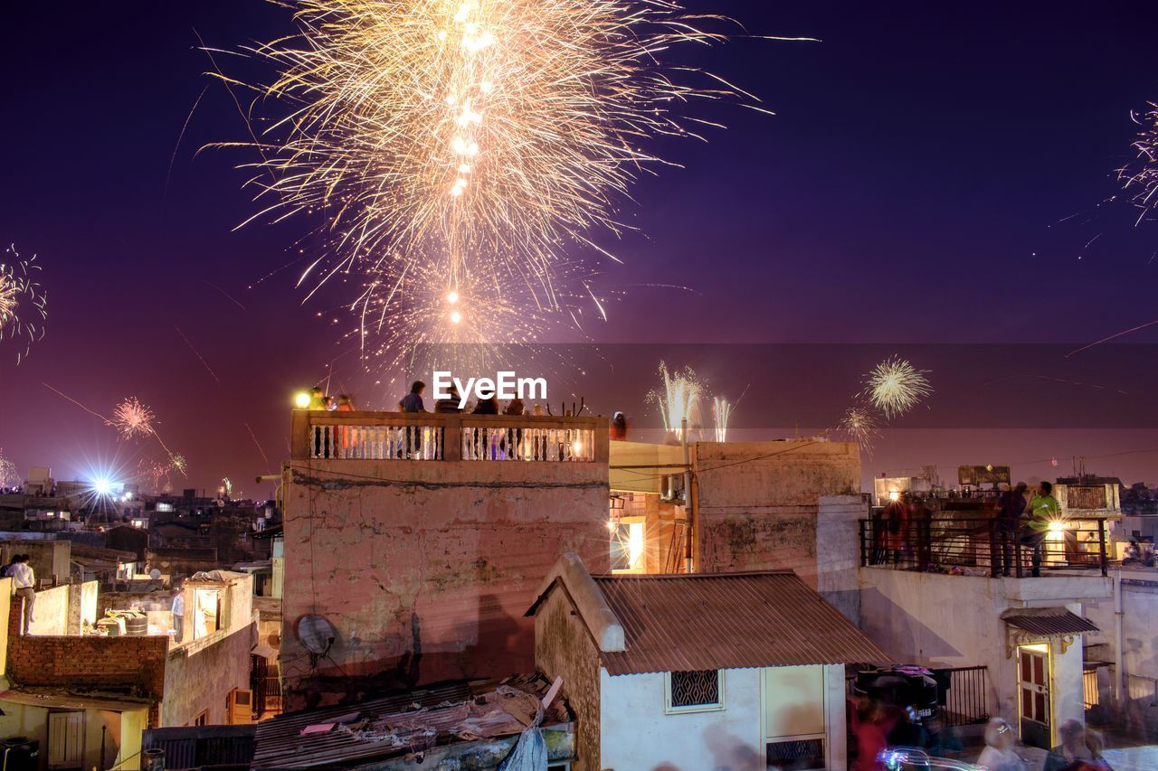 fireworks, architecture, night, celebration, event, illuminated, firework display, building exterior, motion, built structure, arts culture and entertainment, city, firework - man made object, exploding, new year's eve, travel destinations, building, nature, recreation, long exposure, cityscape, sky, outdoors, religion, tradition, town, landmark