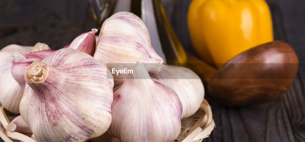 food, food and drink, garlic, plant, freshness, vegetable, produce, spice, healthy eating, wellbeing, ingredient, garlic bulb, onion, close-up, shallot, still life, flower, no people, raw food, indoors, organic, focus on foreground, wood, studio shot