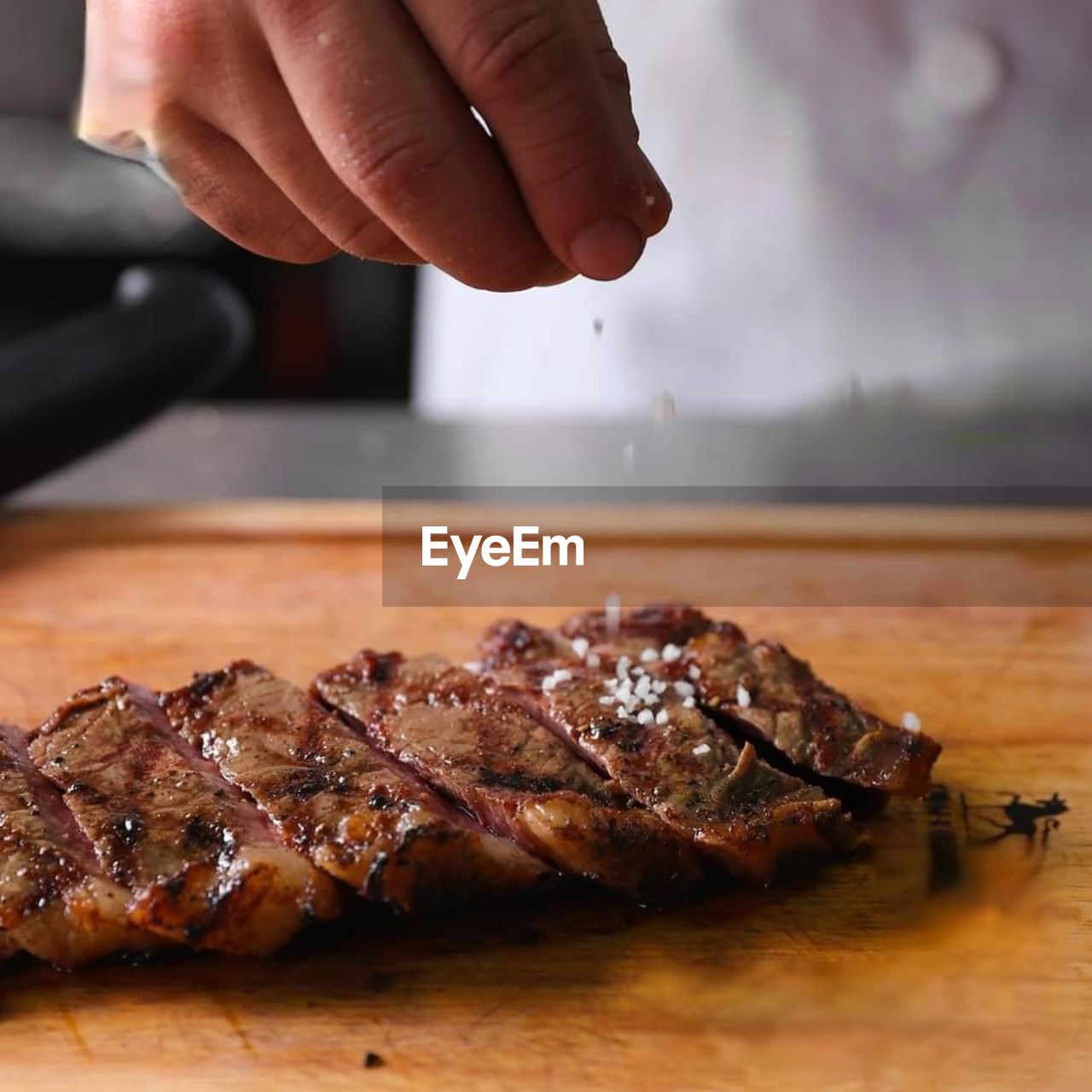 cropped hand of person preparing food on table