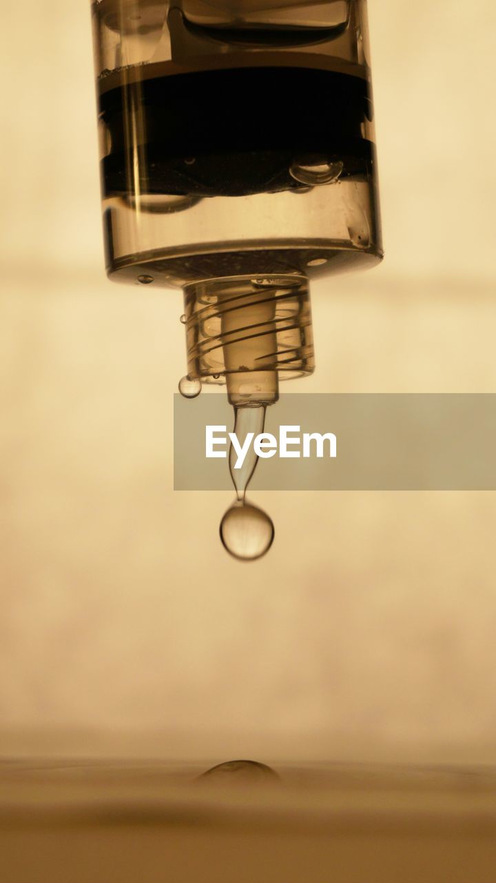 Close-up of water dripping form bottle