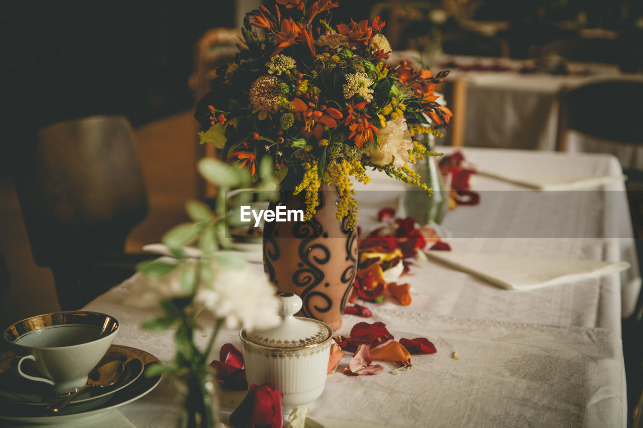 Close-up of flower vase on decorated table