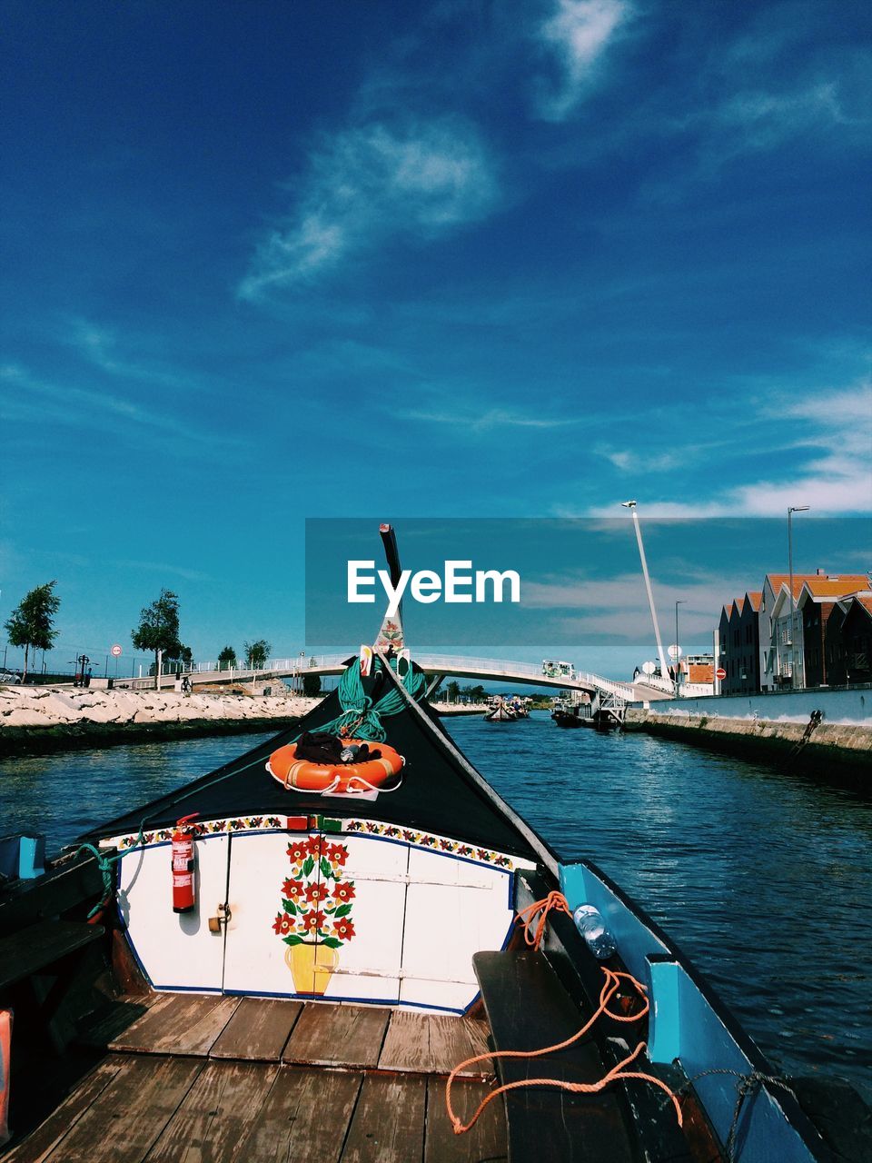 BOAT MOORED AT SEA AGAINST SKY