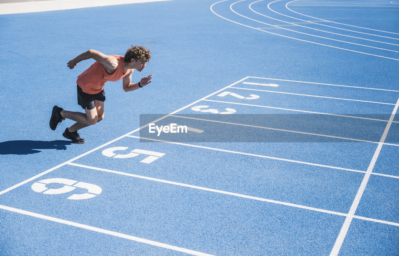 Young athlete running on track