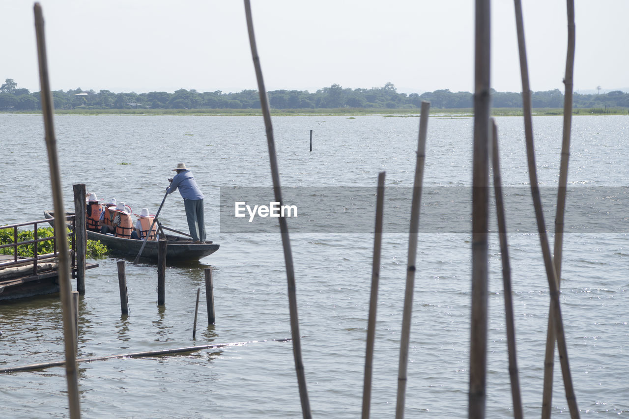 MEN IN BOAT AGAINST SEA