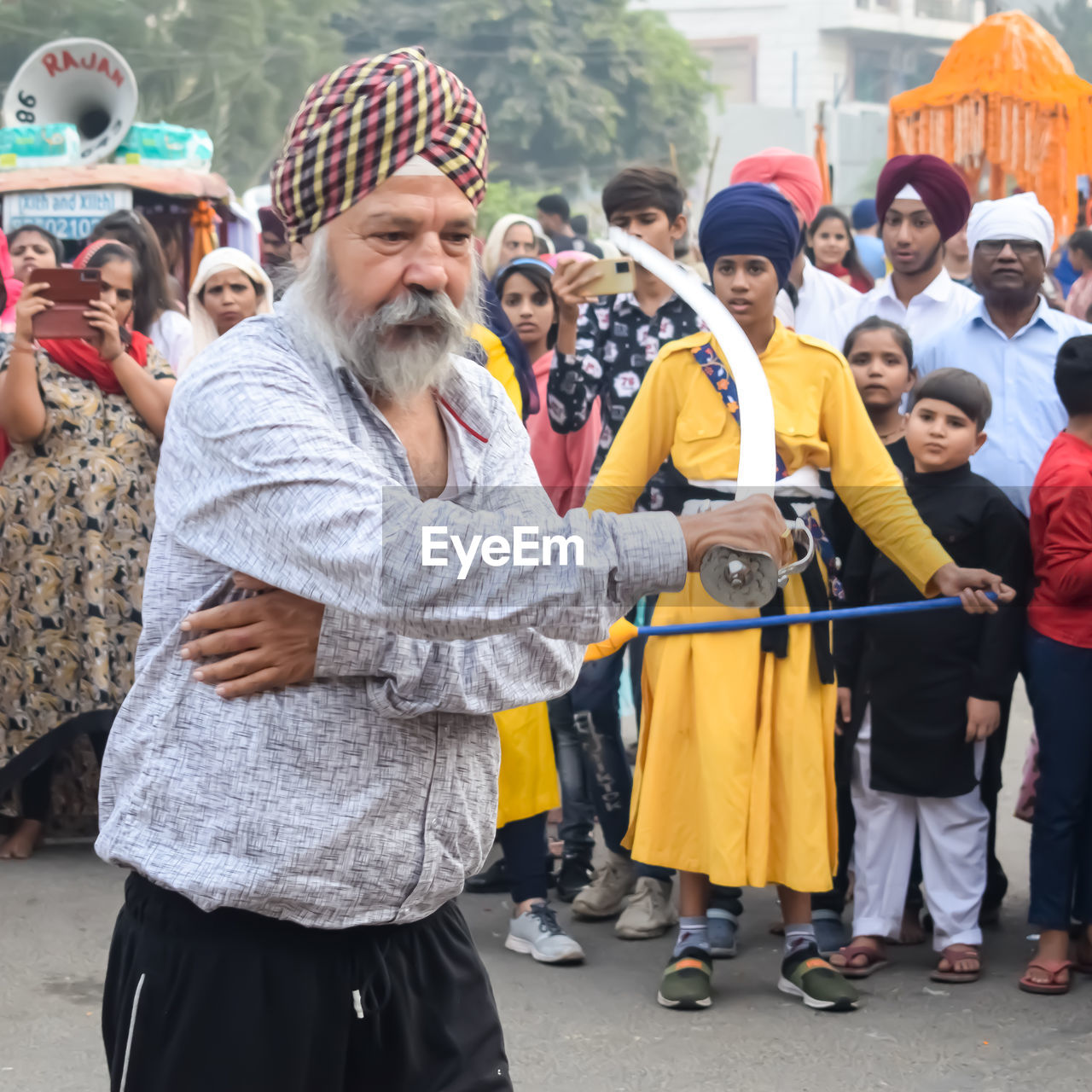 group of people, men, crowd, adult, large group of people, women, city, street, festival, architecture, celebration, standing, arts culture and entertainment, clothing, person, event, smiling, happiness, togetherness, day, emotion, female, outdoors, lifestyles