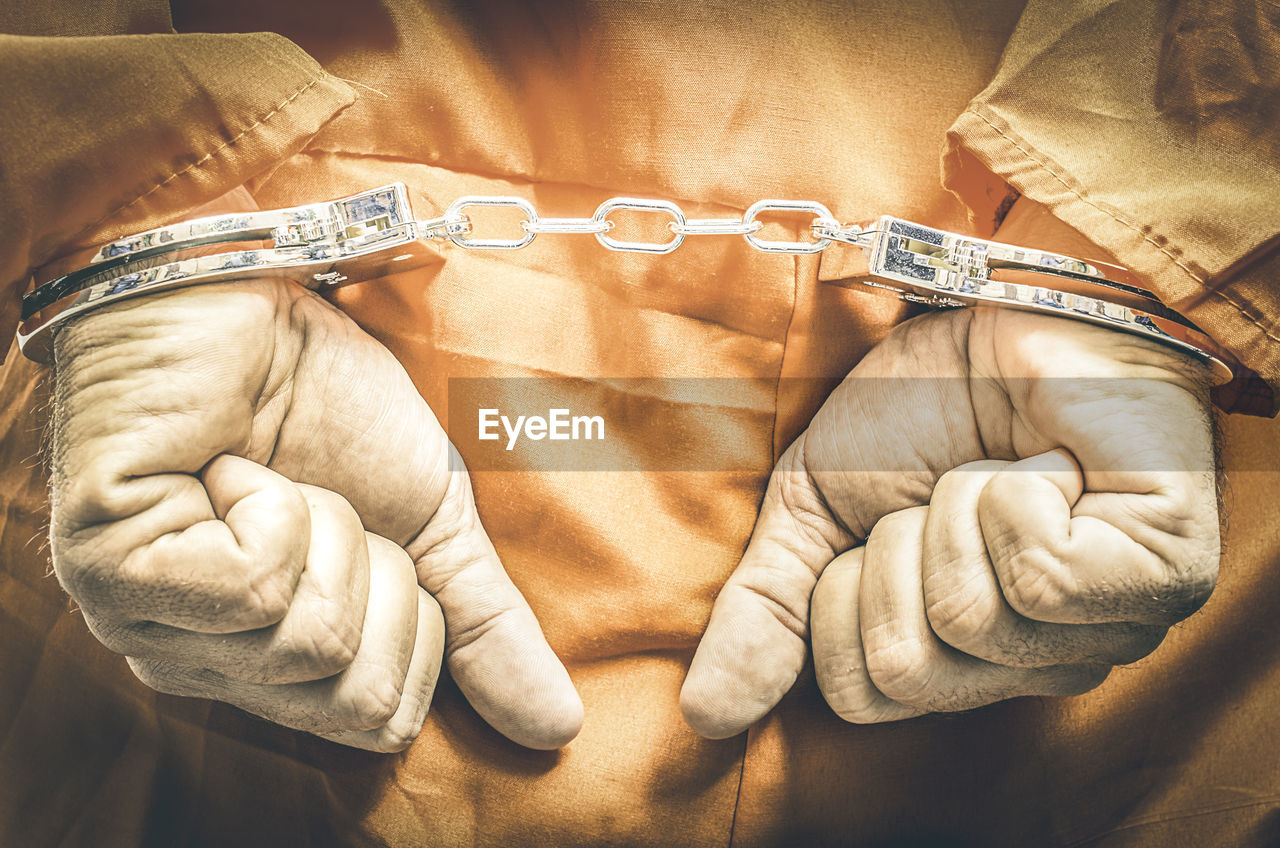 Midsection of criminal with handcuffs