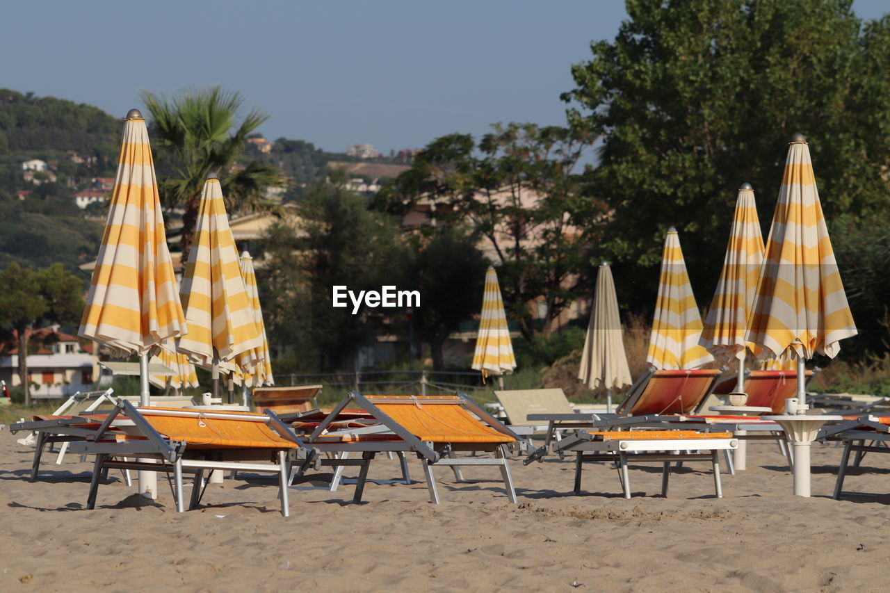 CHAIRS AND TABLES ON BEACH