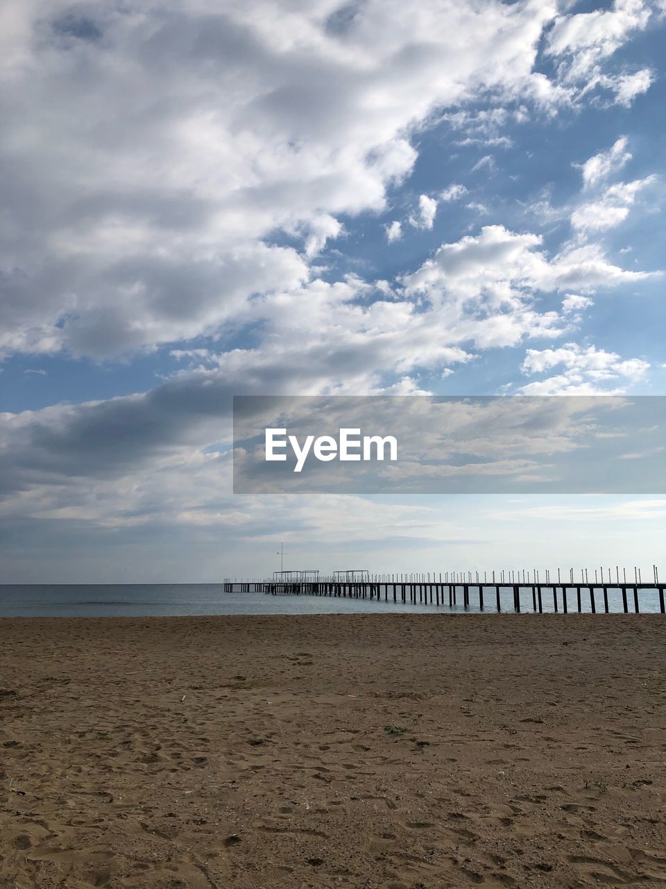 SCENIC VIEW OF SANDY BEACH AGAINST SKY