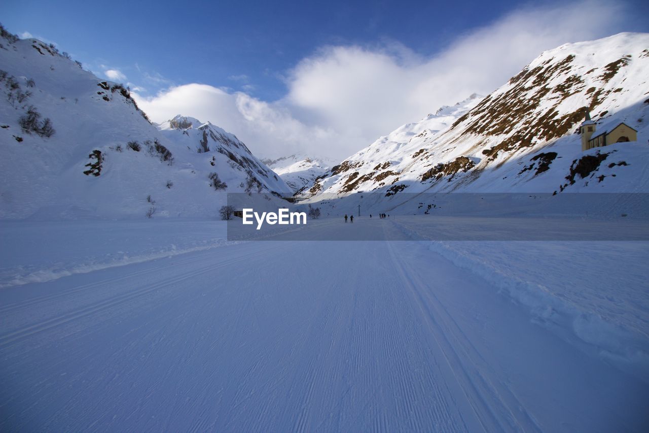 Scenic view of snow covered mountains against sky