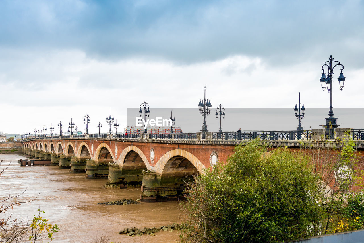 Pont de pierre over garonne river against sky in city