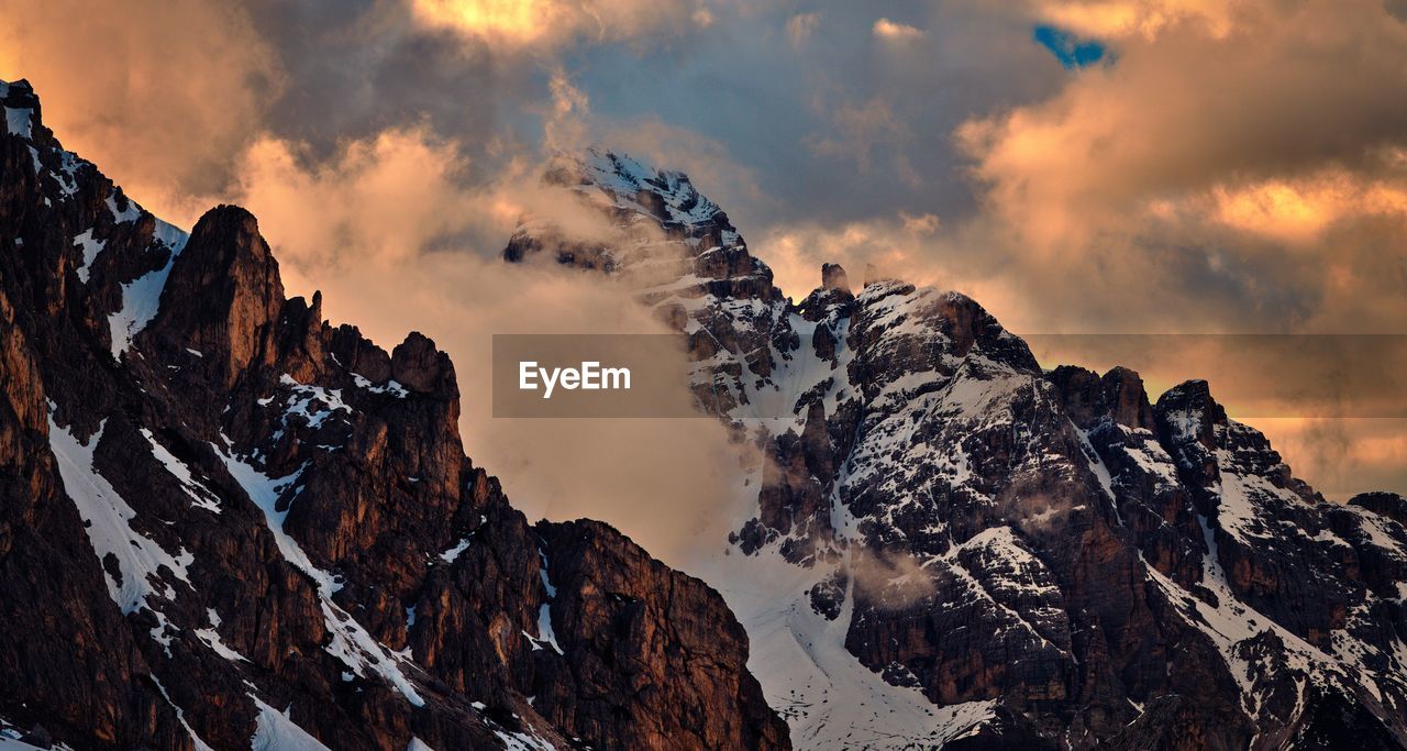 Scenic view of snowcapped mountains against sky during sunset