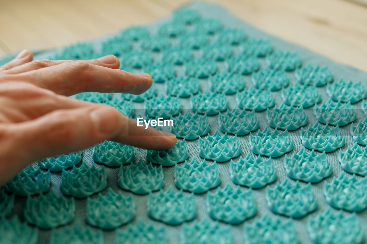 CLOSE-UP OF PERSON WORKING ON CARPET