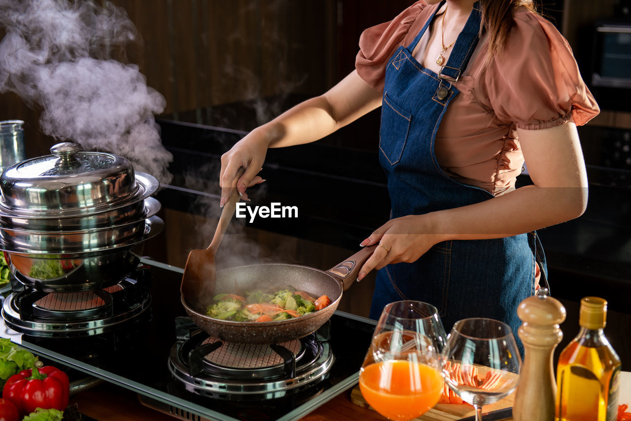 midsection of woman preparing food on table