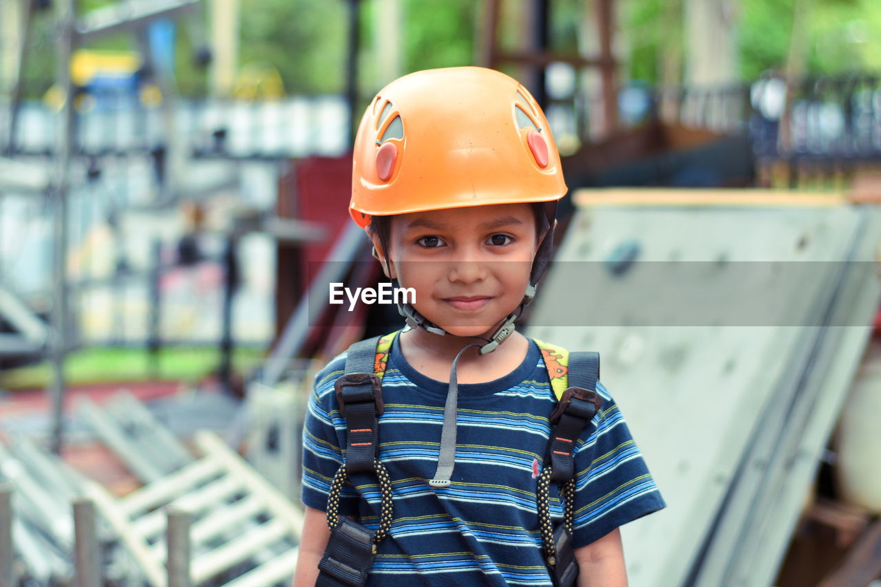 Portrait of little boy wearing helmet and harness