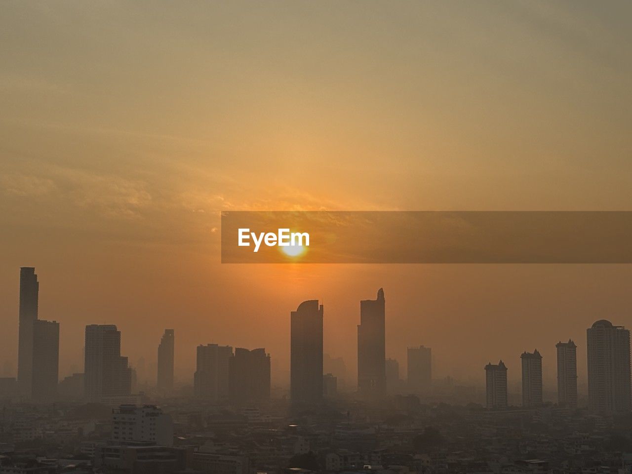 city, horizon, building exterior, sky, skyscraper, architecture, office building exterior, urban skyline, landscape, built structure, cityscape, sunset, building, skyline, dawn, nature, haze, city life, sunlight, residential district, no people, sun, downtown district, travel destinations, afterglow, fog, outdoors, cloud, dramatic sky, silhouette, environment, metropolitan area, evening, development, tower, business, high angle view, beauty in nature, travel, scenics - nature