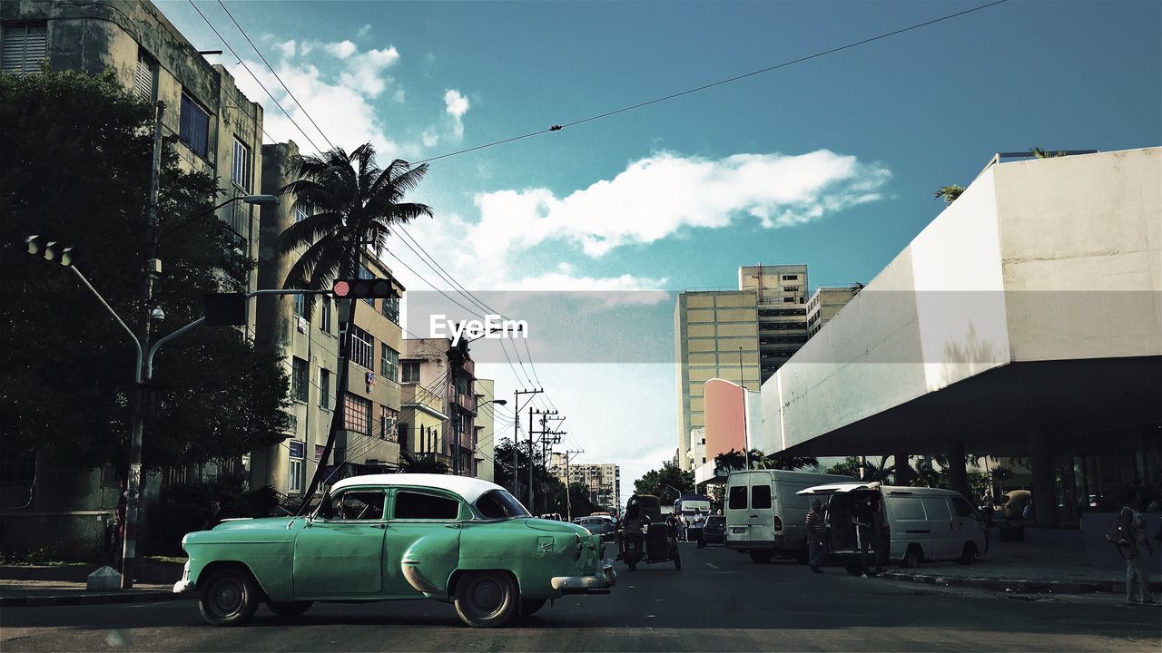 CARS PARKED ON ROAD IN CITY