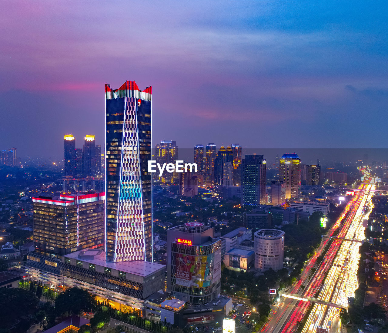 Illuminated cityscape against sky at night