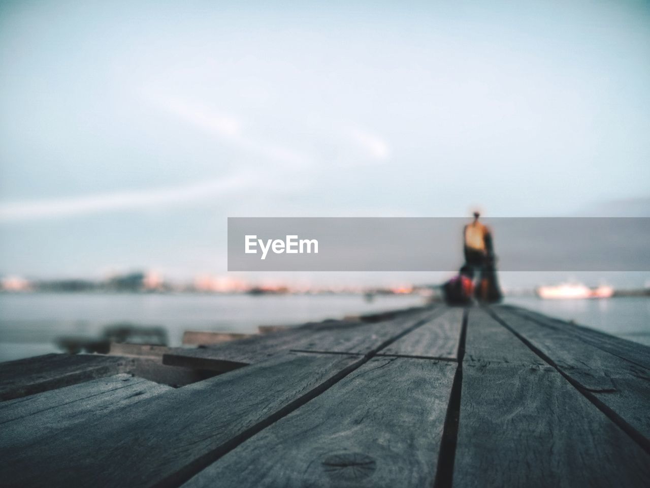 People standing on pier over sea against sky